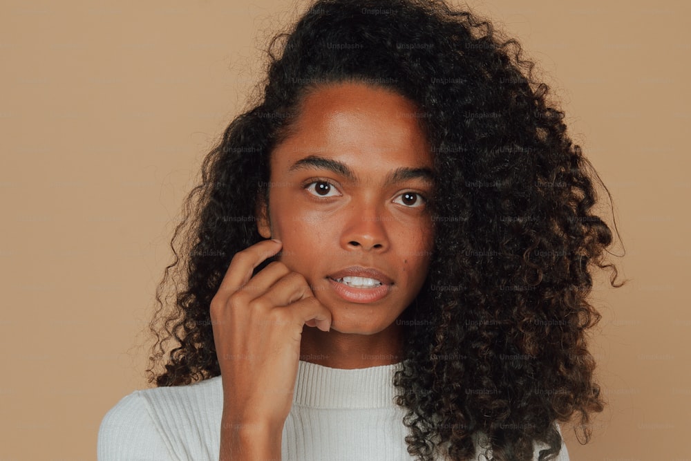 a close up of a person with curly hair