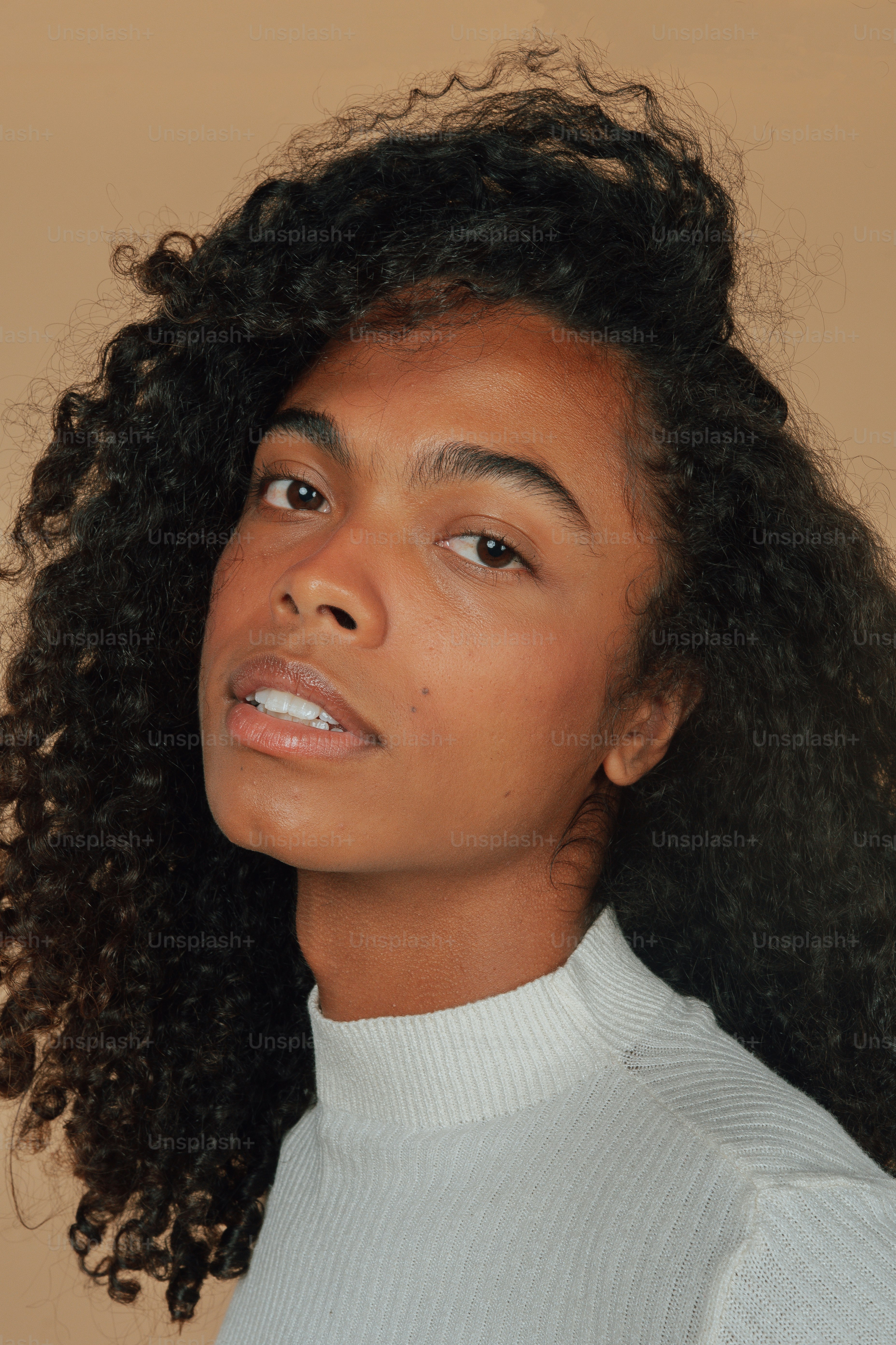 a close up of a woman with curly hair
