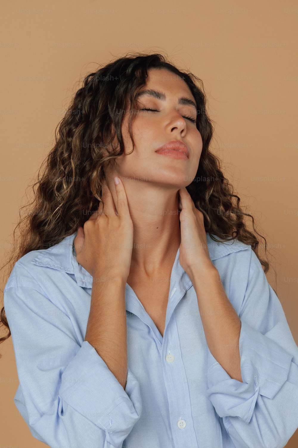 a woman with her hands on her neck