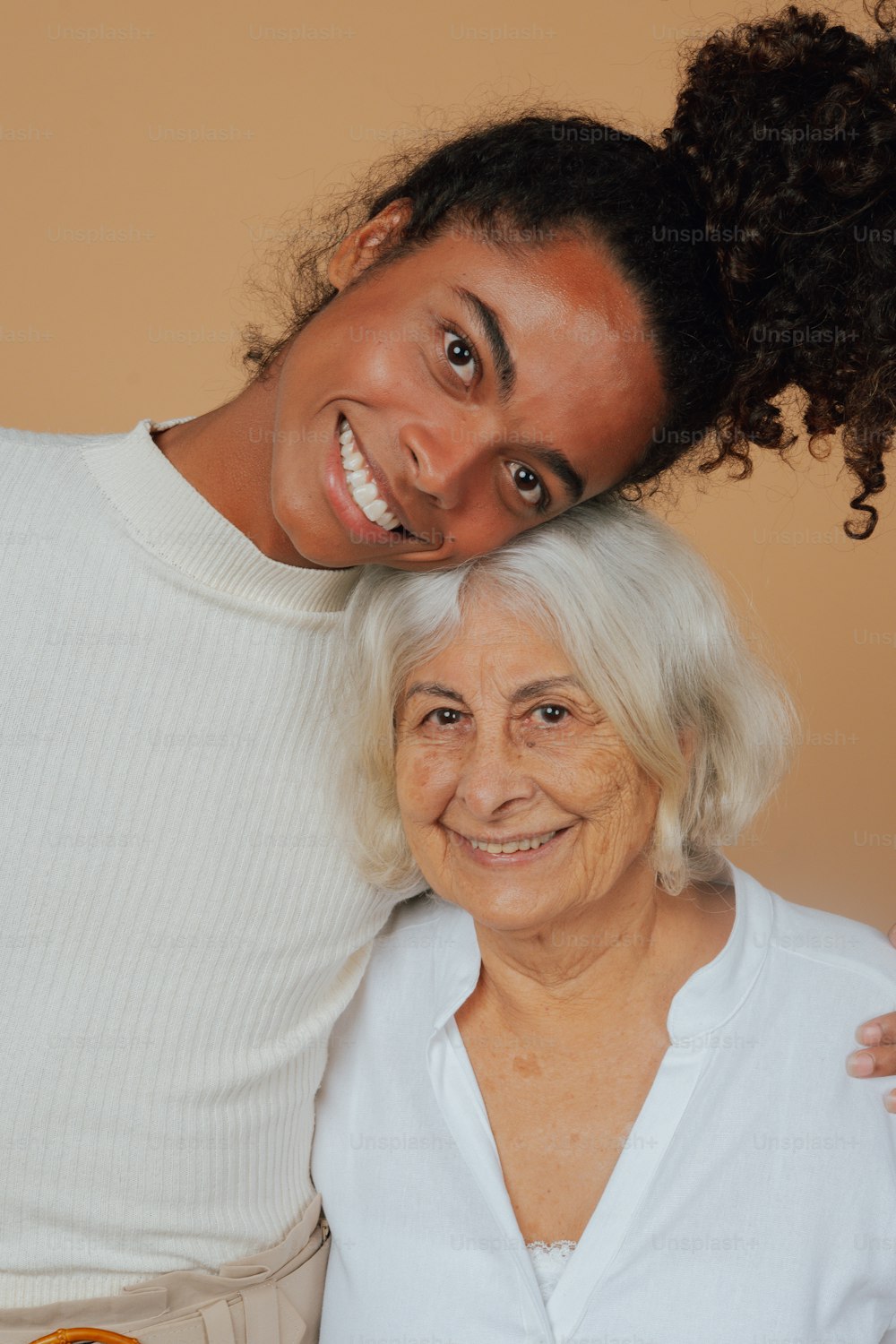 a woman standing next to an older woman