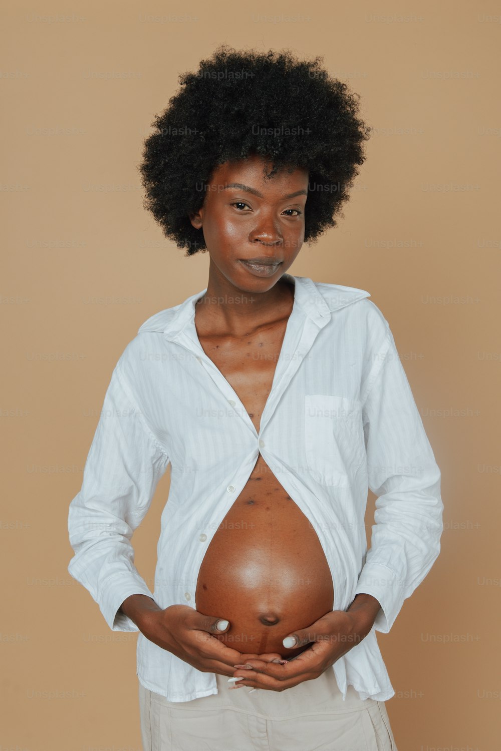 a woman holding a pregnant belly in her hands