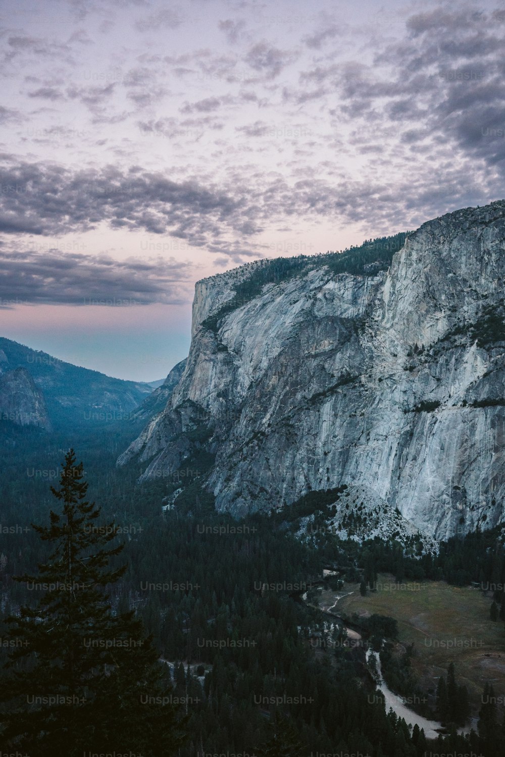 a view of a mountain with a cloudy sky