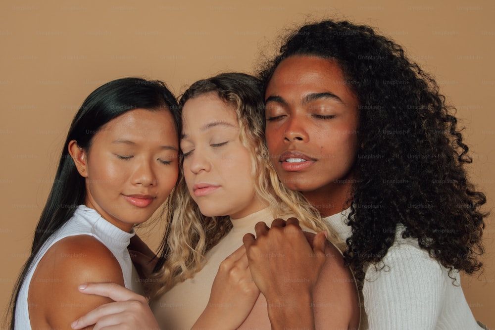 a group of three women standing next to each other