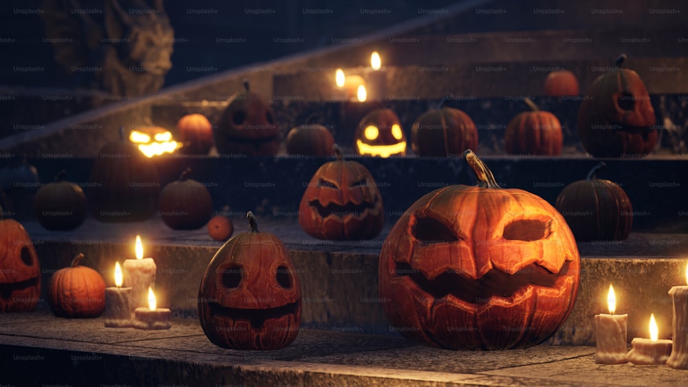 a group of carved pumpkins with lit candles