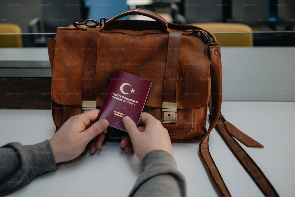 a person holding a passport and a bag