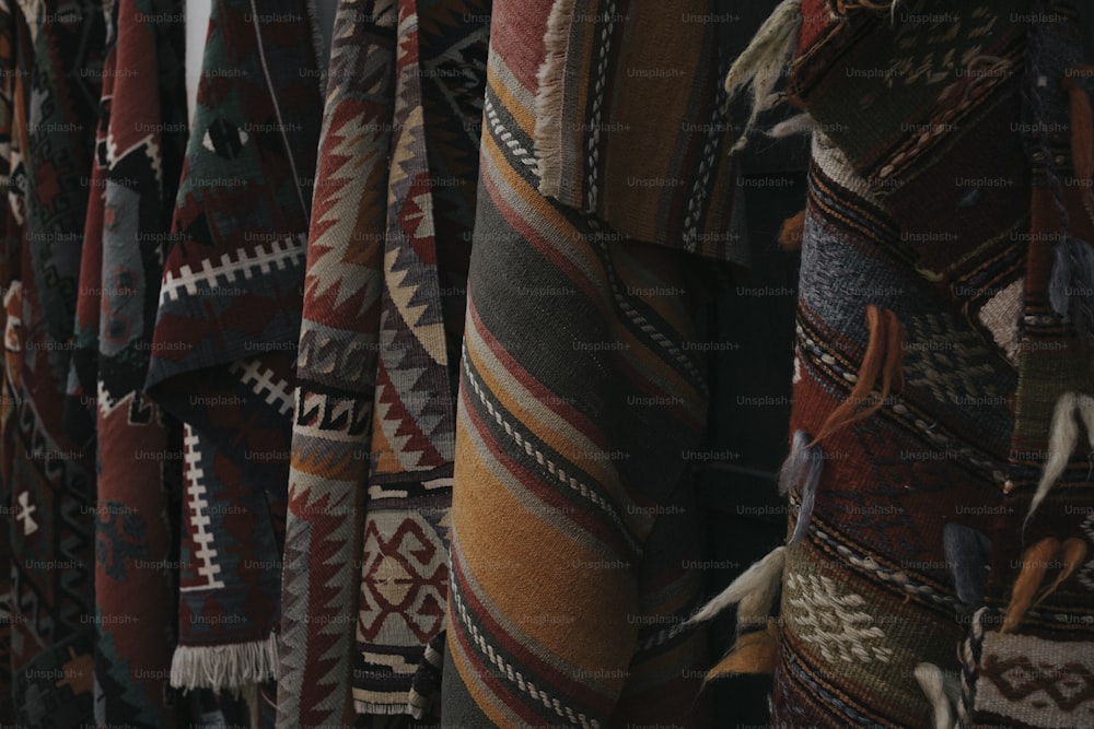 a bunch of blankets hanging up in a room