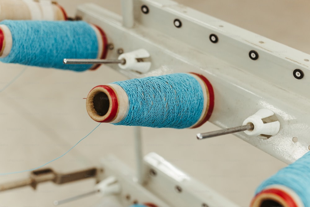 a couple of spools of thread on a machine