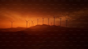 a group of windmills on a hill at sunset