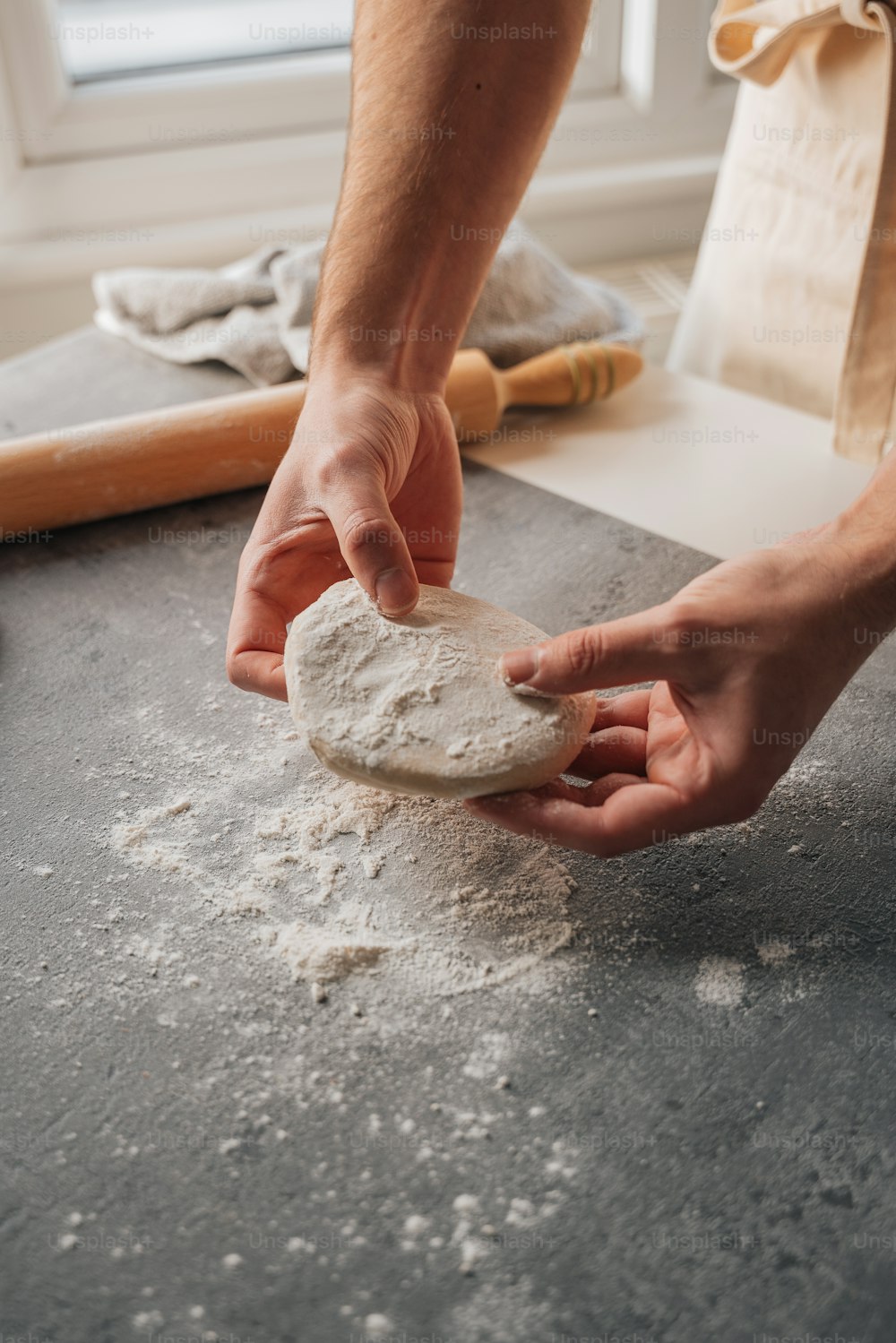 a person is kneading a cookie on a table
