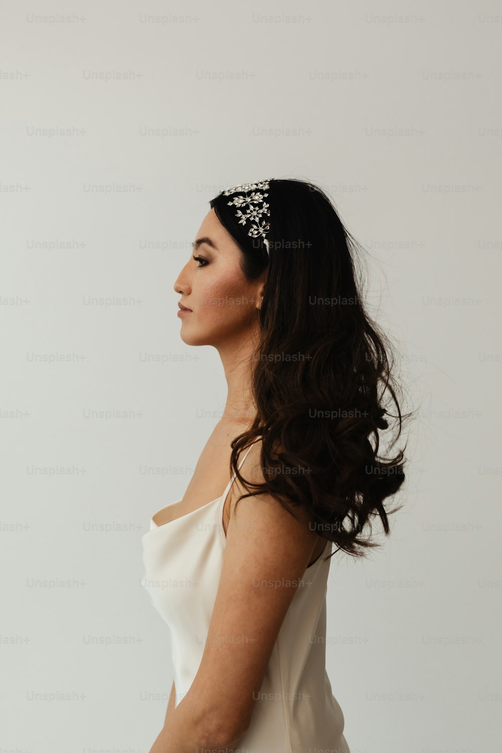 a woman wearing a white dress and a headband