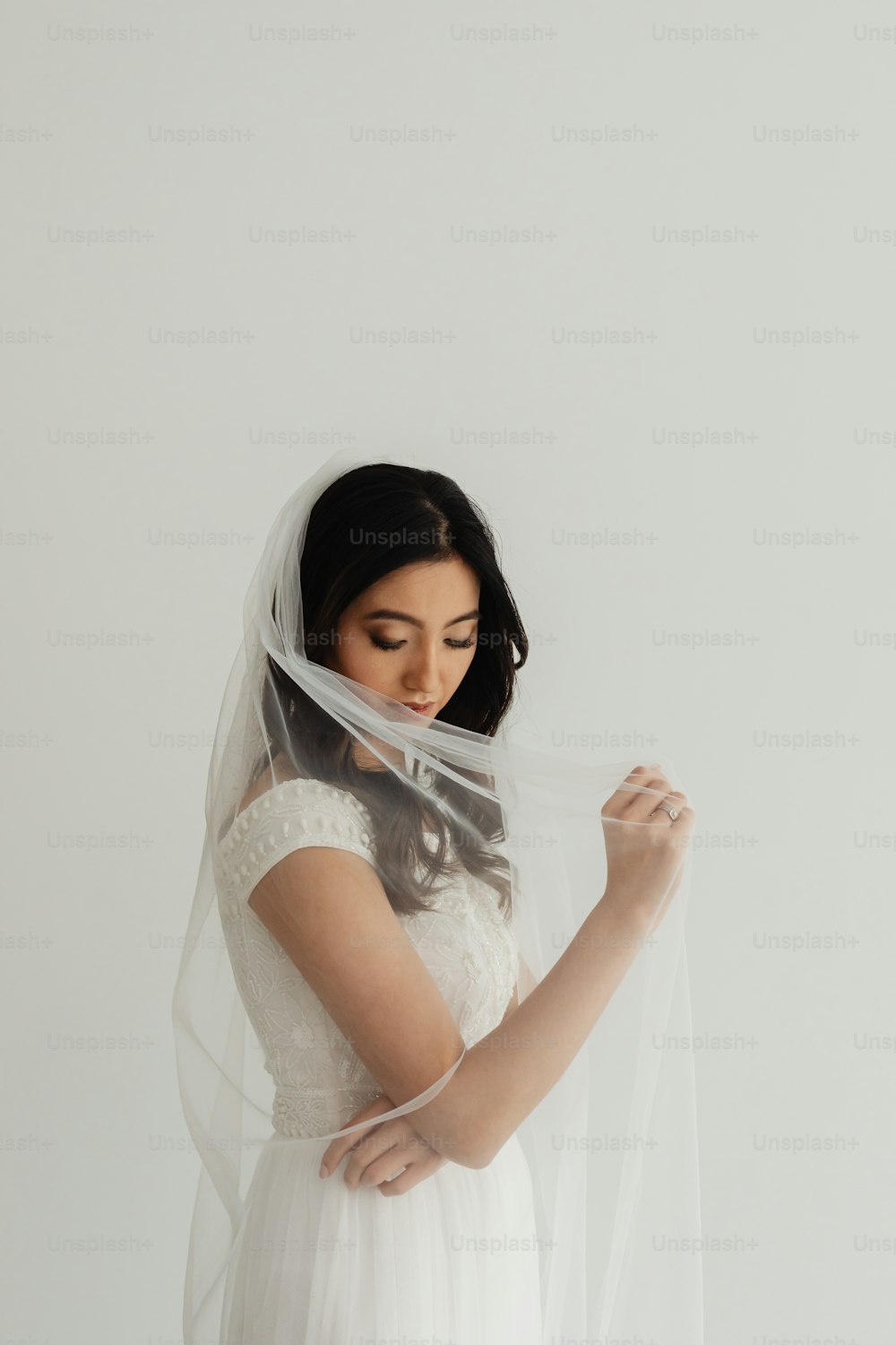 a woman wearing a veil and a wedding dress