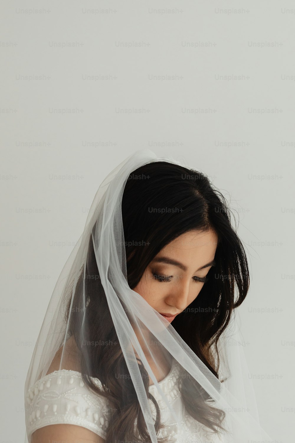 a woman in a white dress wearing a veil