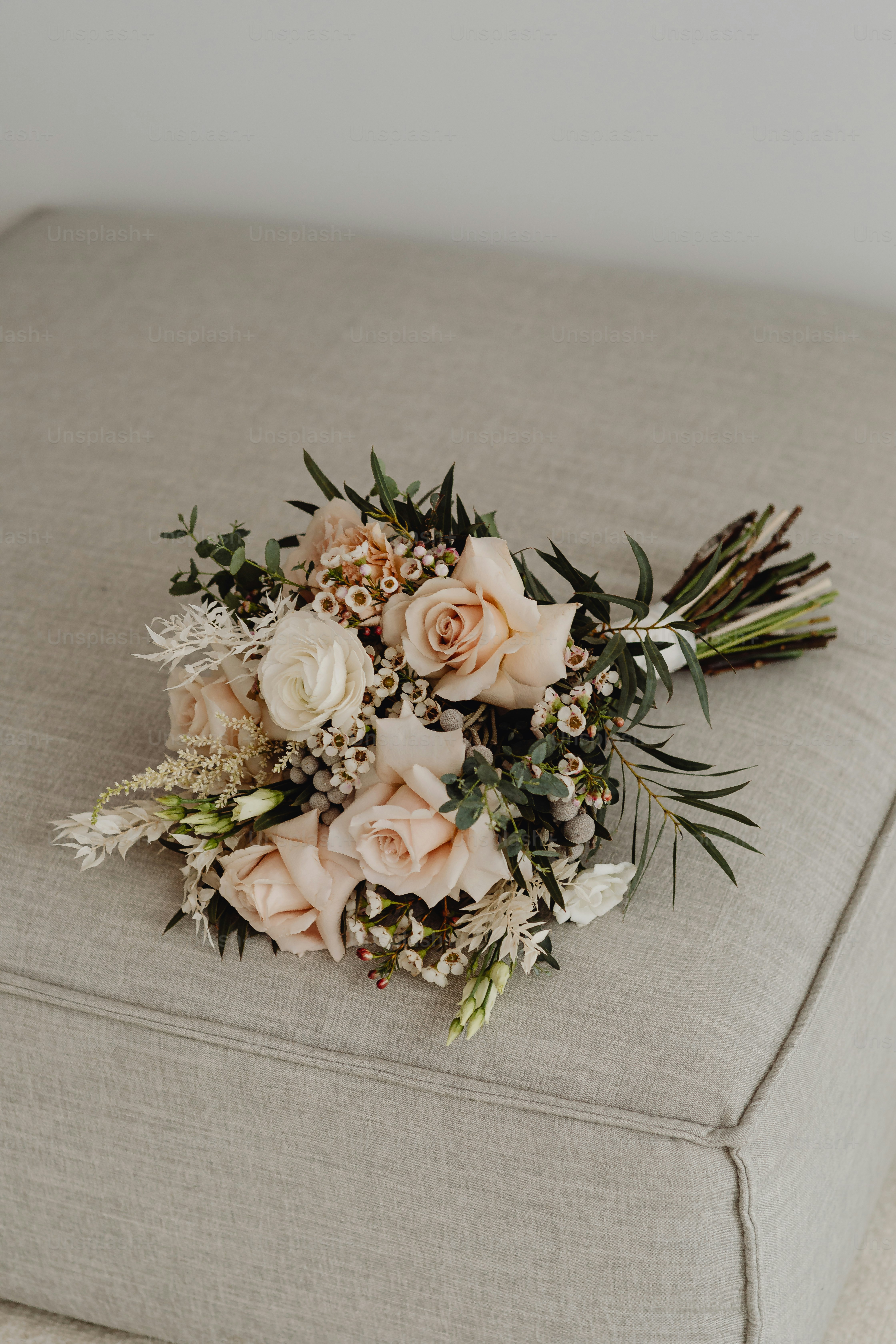 a bouquet of flowers sitting on top of a couch