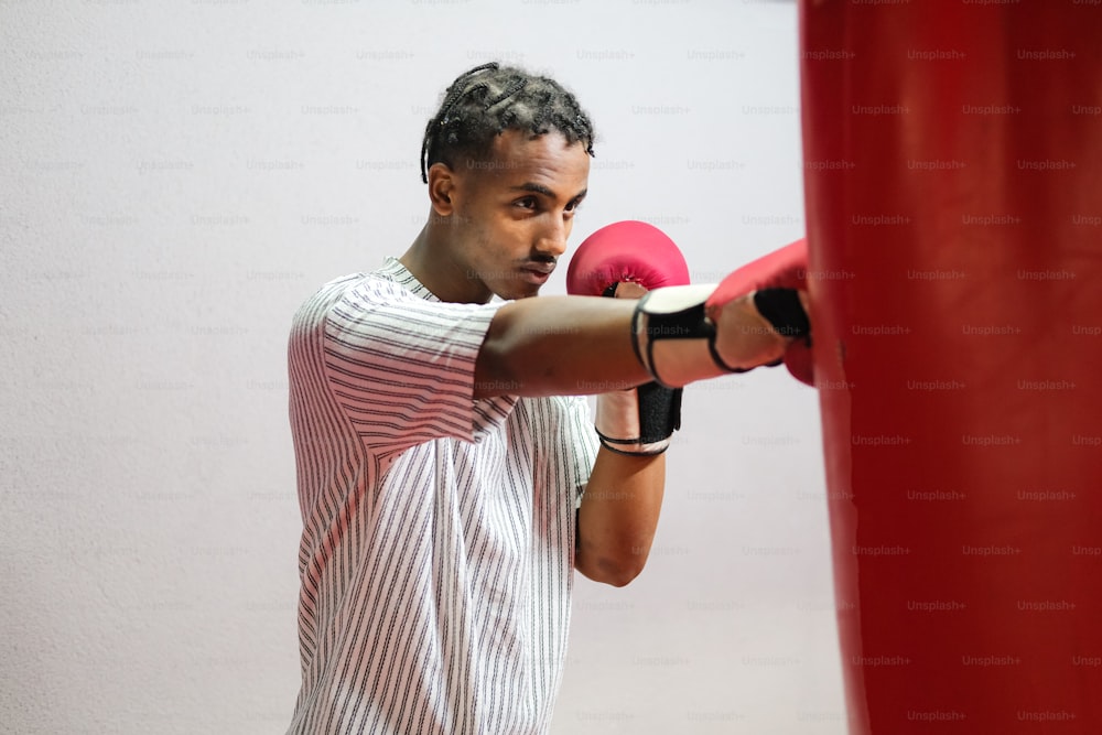 a man in a striped shirt and red boxing gloves