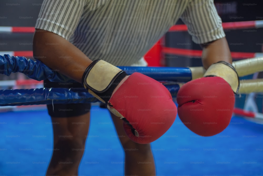 a close up of a person wearing boxing gloves