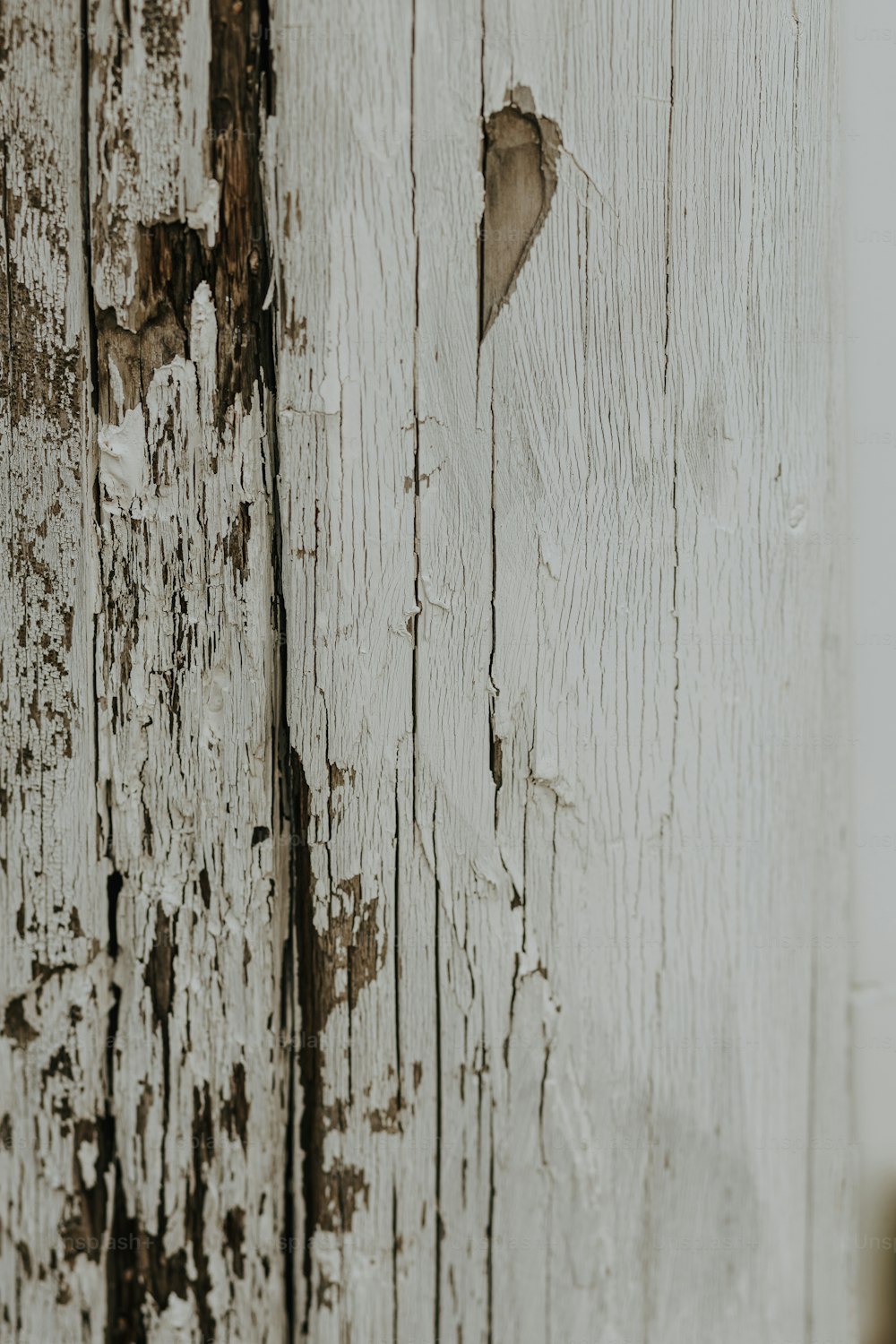 a close up of a wooden door with peeling paint