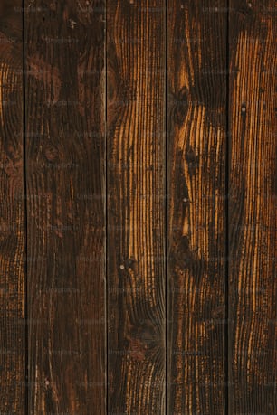 a close up of a wooden wall with a clock on it