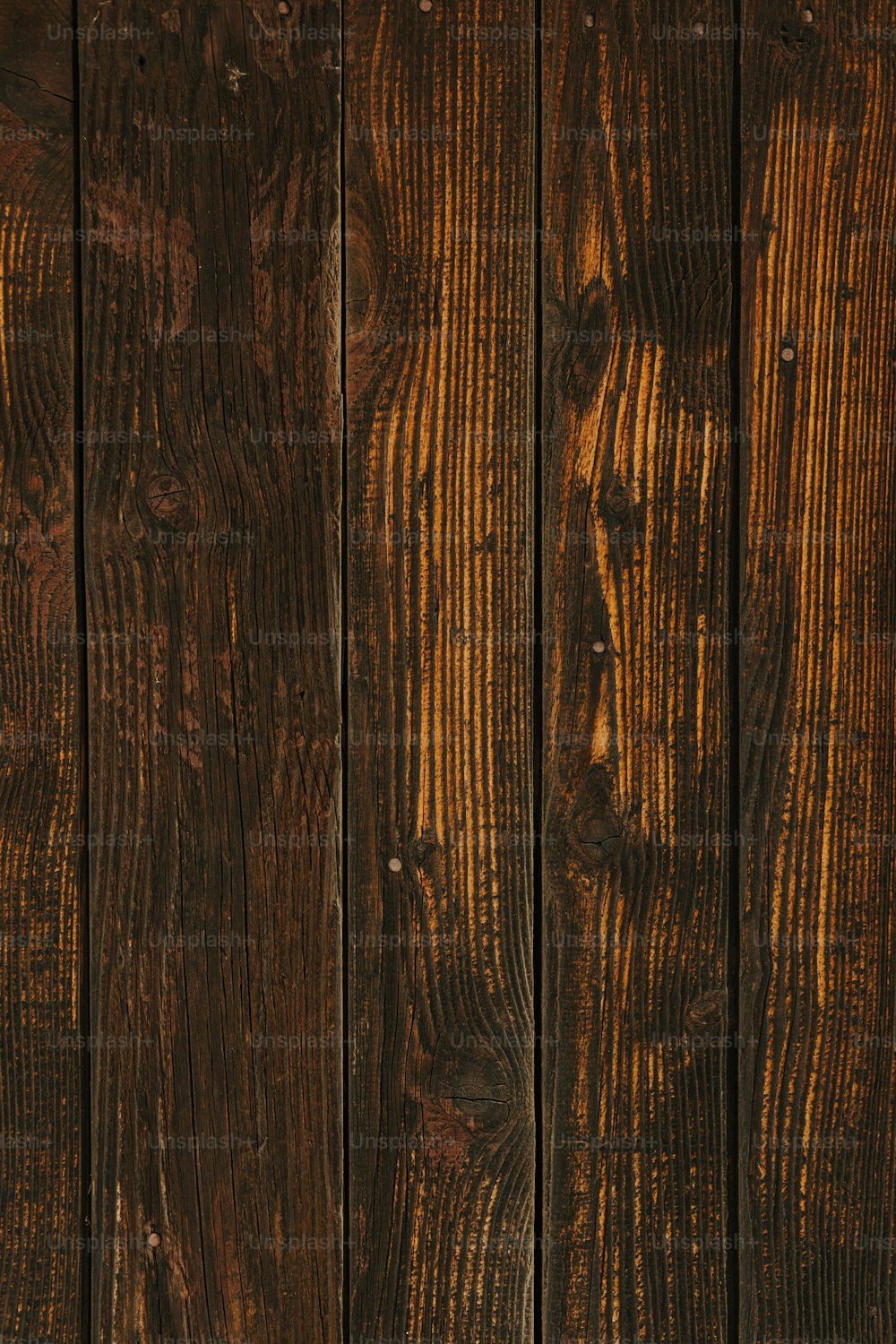 a close up of a wooden wall with a clock on it