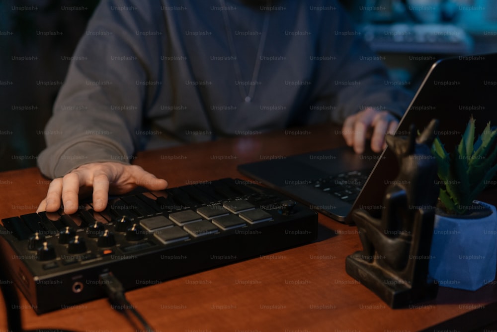 a man is typing on a black keyboard