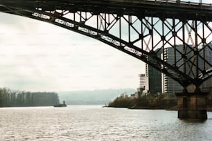 a bridge over a river with a boat in the water