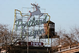 a large metal sign with a deer on top of it