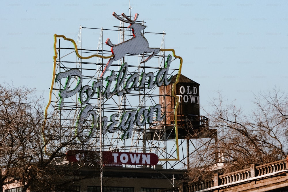 a large metal sign with a deer on top of it