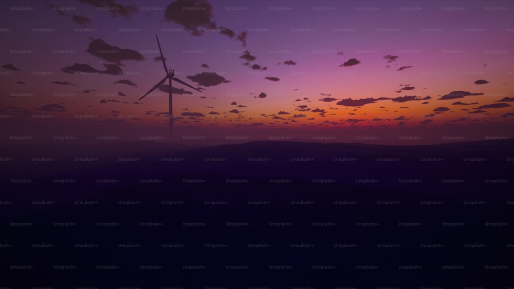 Una puesta de sol con una turbina eólica en la distancia