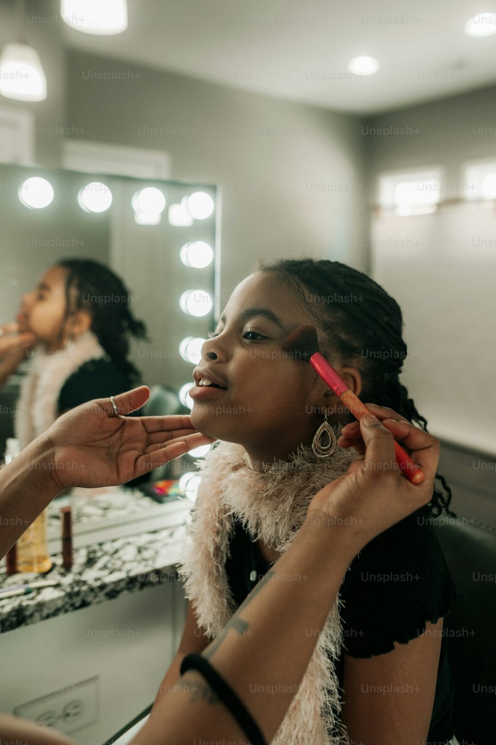 a woman getting her makeup done in a salon