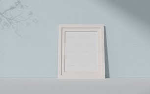 a white picture frame sitting on top of a shelf