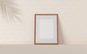 a wooden framed mirror on a shelf next to a plant