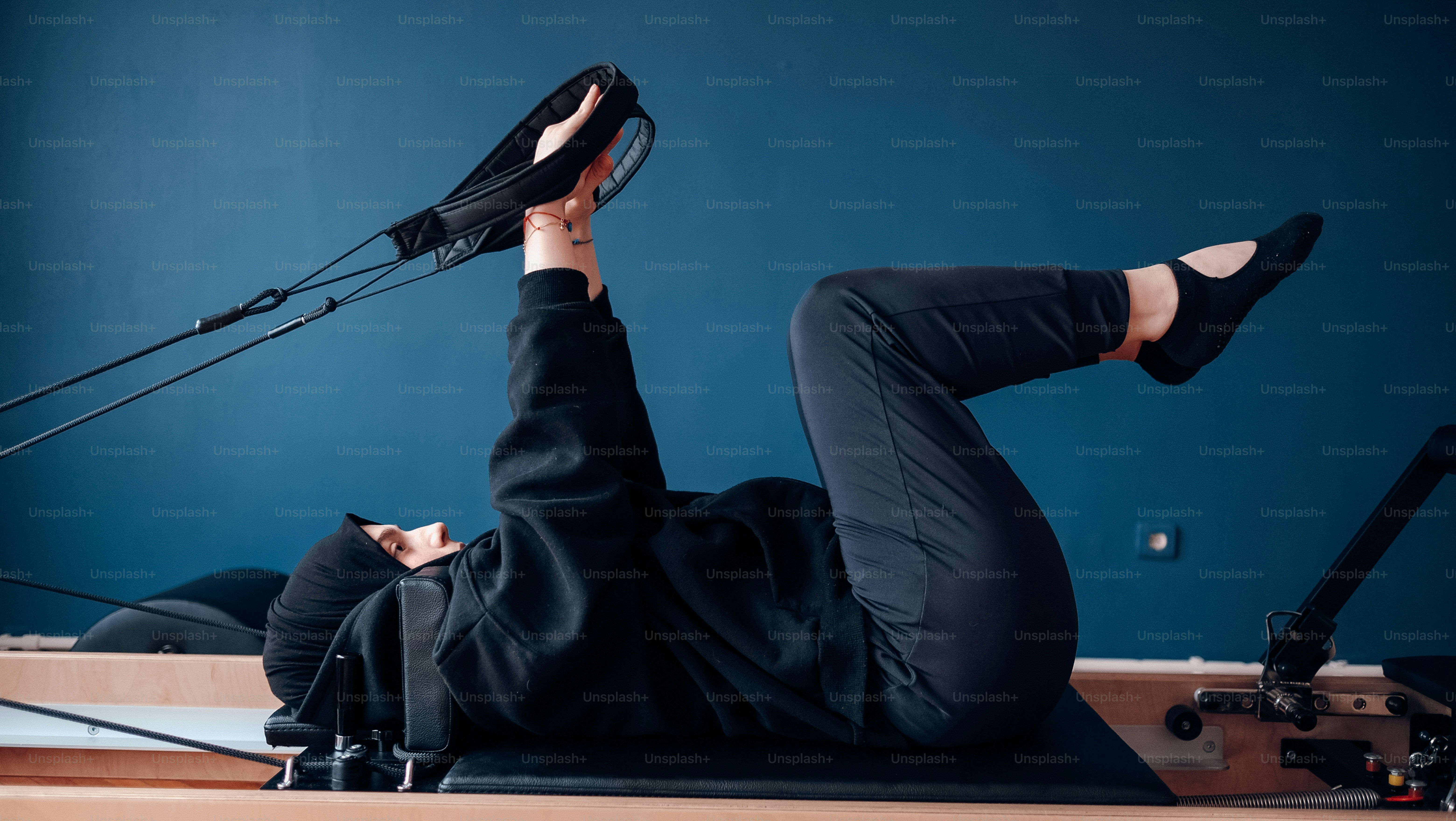 a woman laying on the ground with her legs up