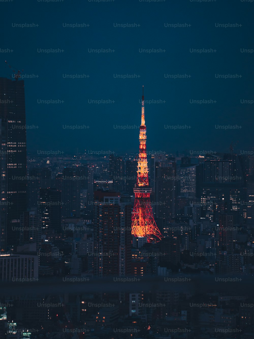 the eiffel tower is lit up in red photo – Tokyo tower Image on Unsplash