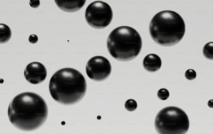 a group of black balls floating on top of a white surface
