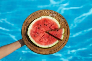 a piece of watermelon is in a wooden bowl