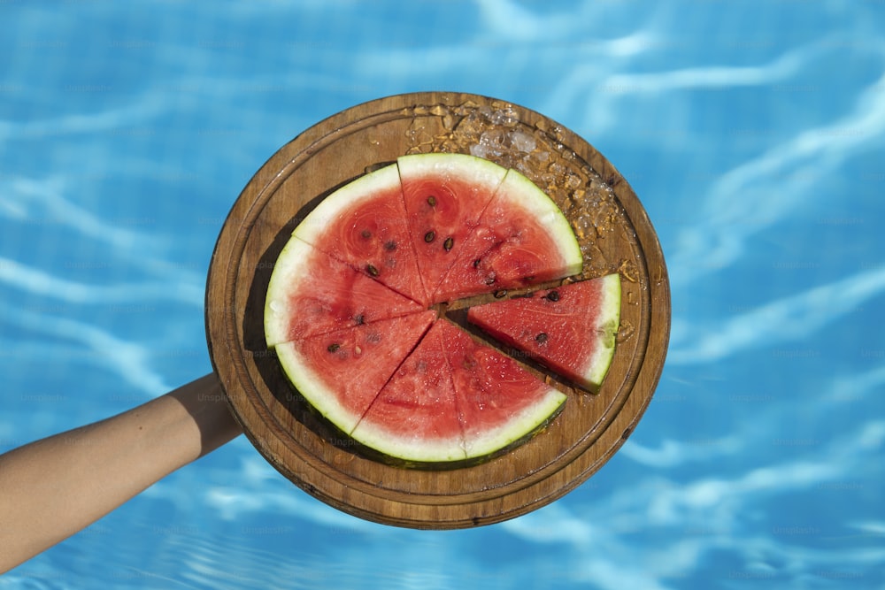 a piece of watermelon is in a wooden bowl