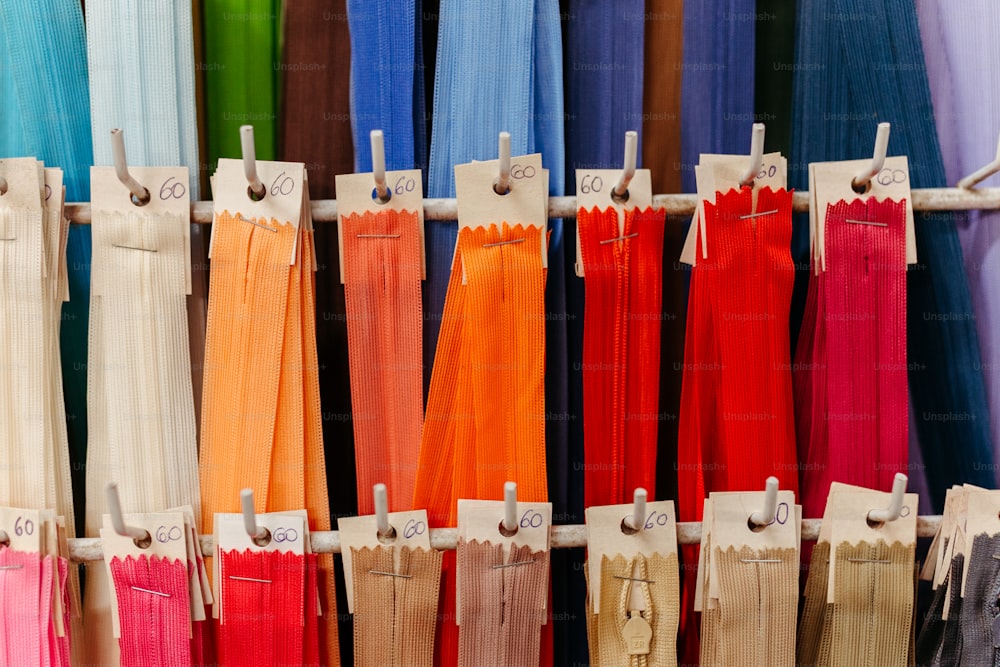 a display of different colored pants hanging on a rack