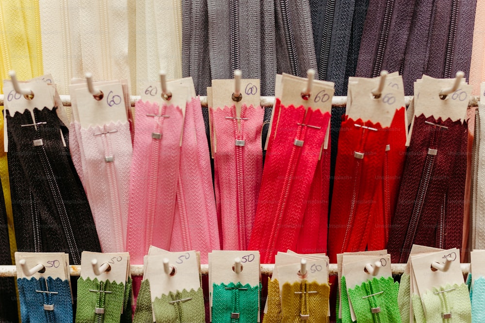 a display of different colored pants and ties