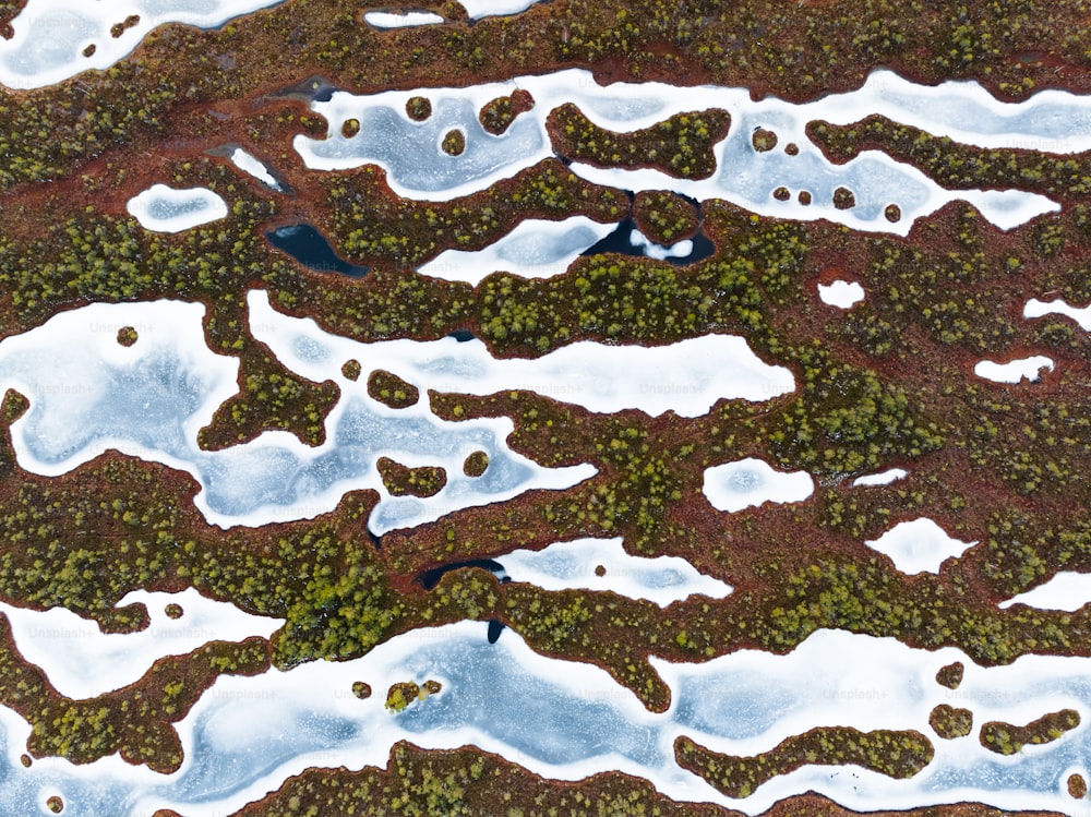 an aerial view of a patch of land covered in snow