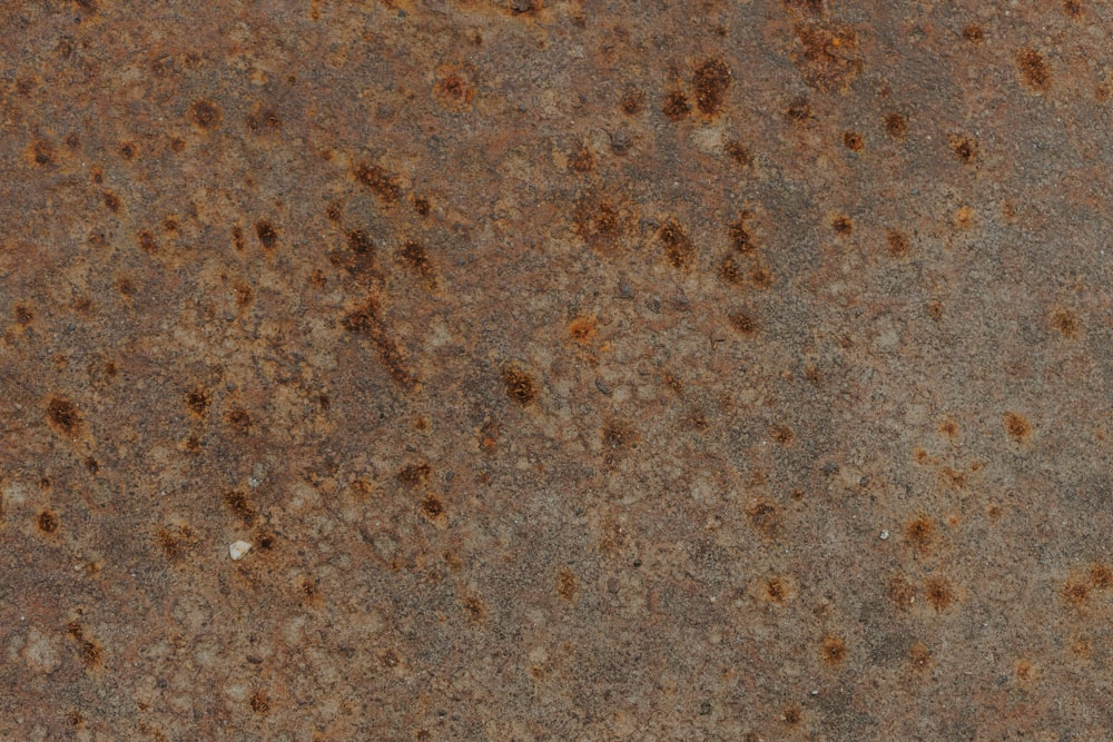 a close up of a metal surface with rust on it