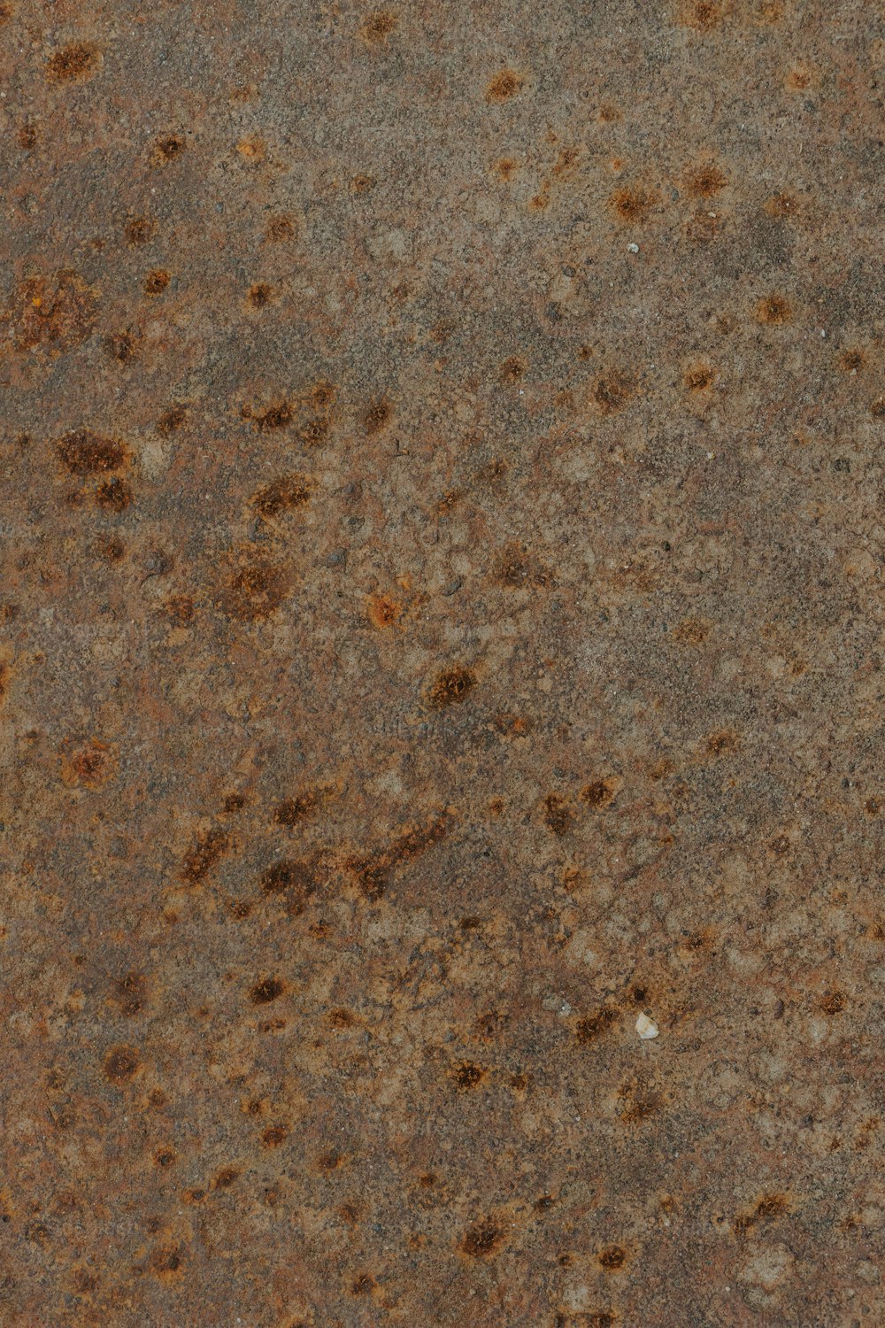a close up of a metal surface with brown spots