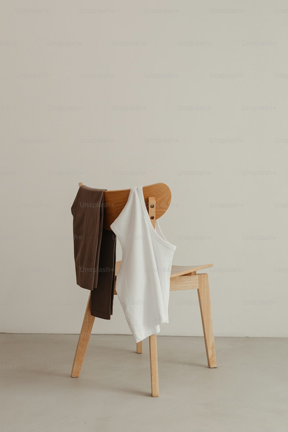 a wooden chair with a white shirt on it