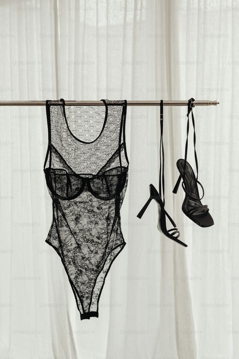 A pair of lingerie bras hanging from a clothes line photo – Heels