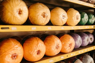 a row of yarn balls sitting on top of a shelf