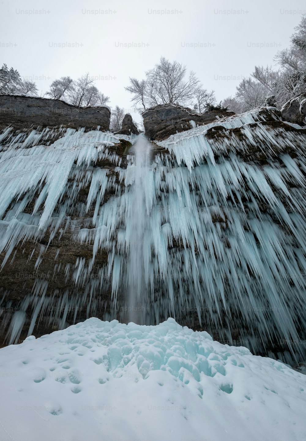 a frozen waterfall with water running down it