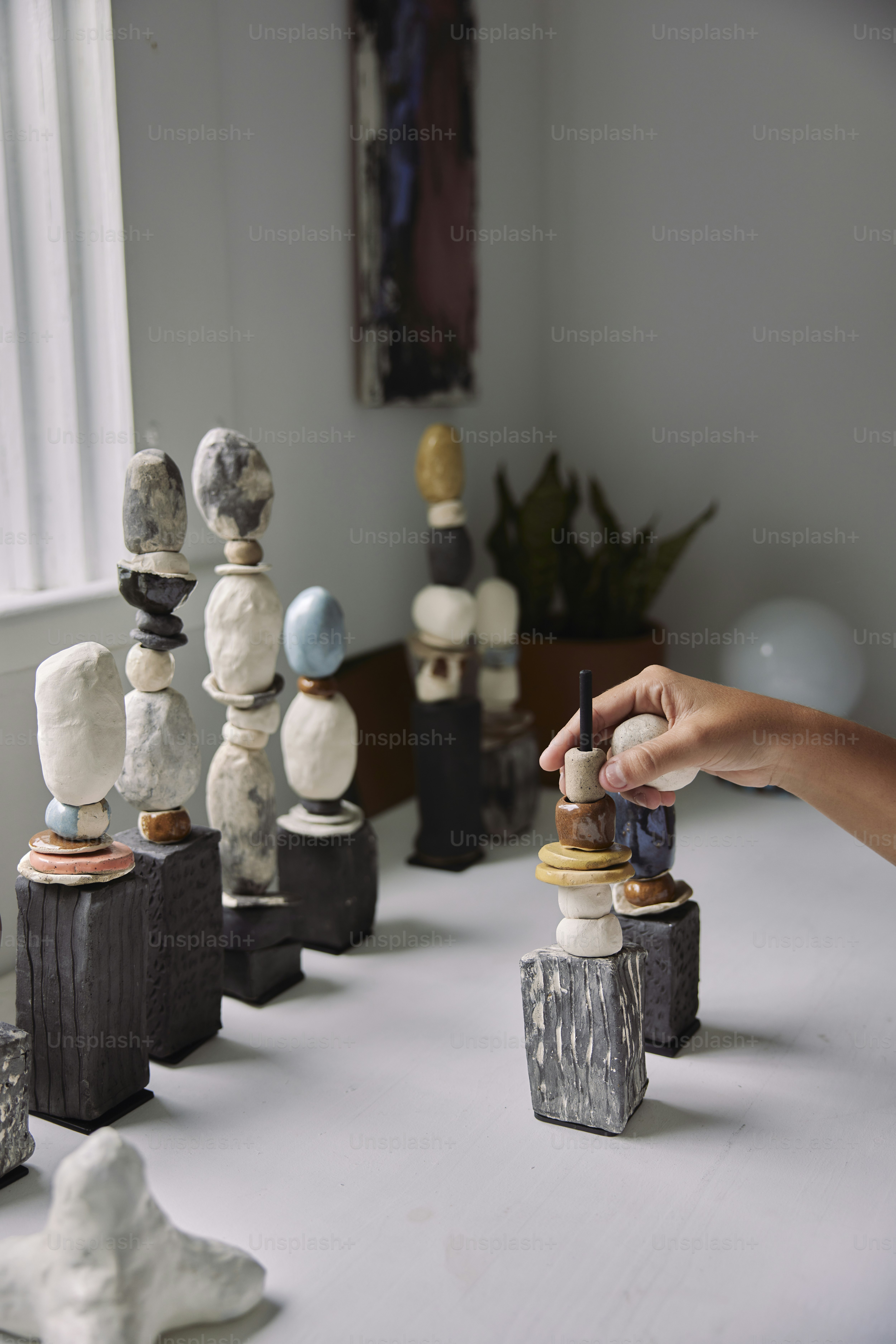 a person is putting a piece of art on a table