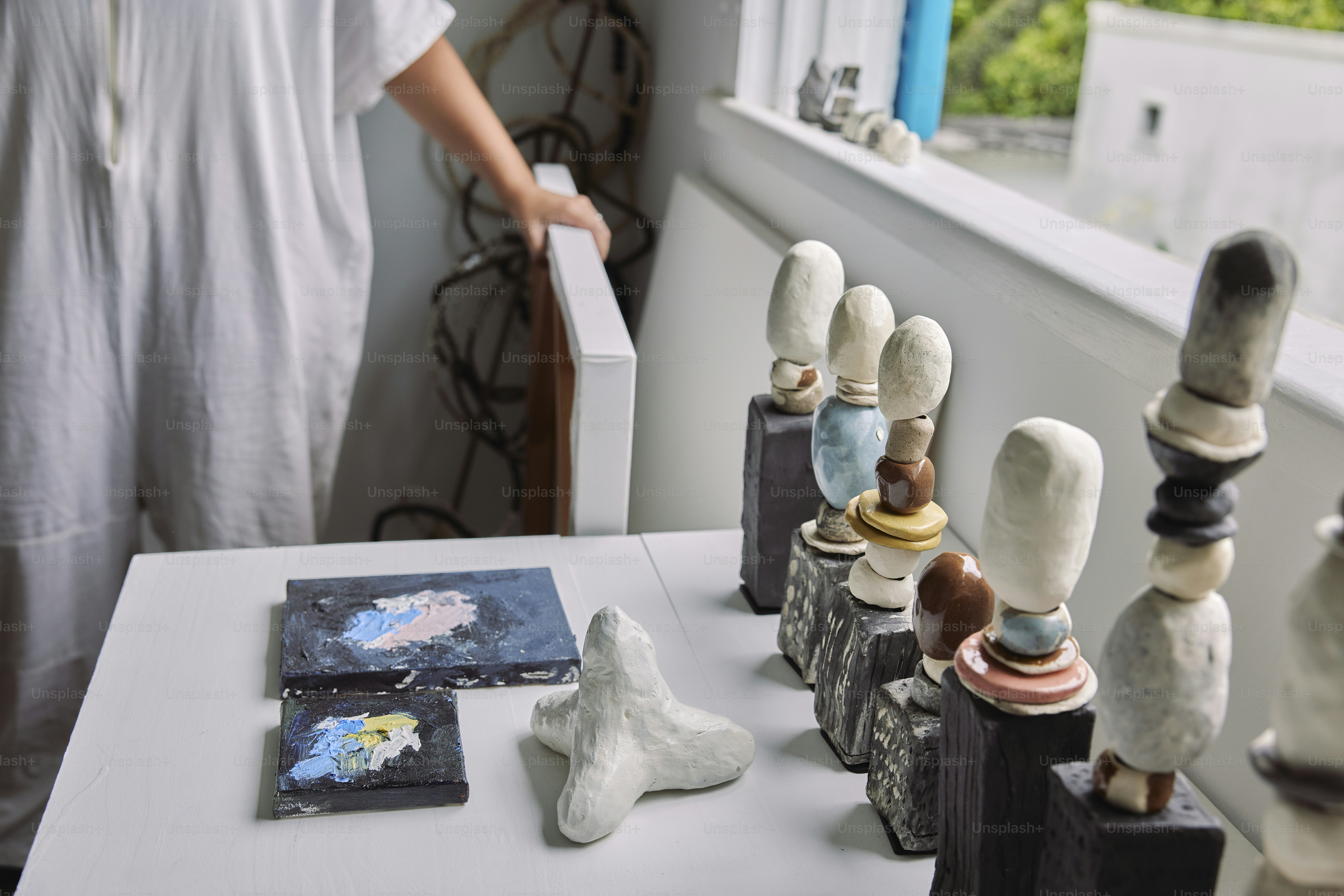 a person standing next to a table with a bunch of different items on it