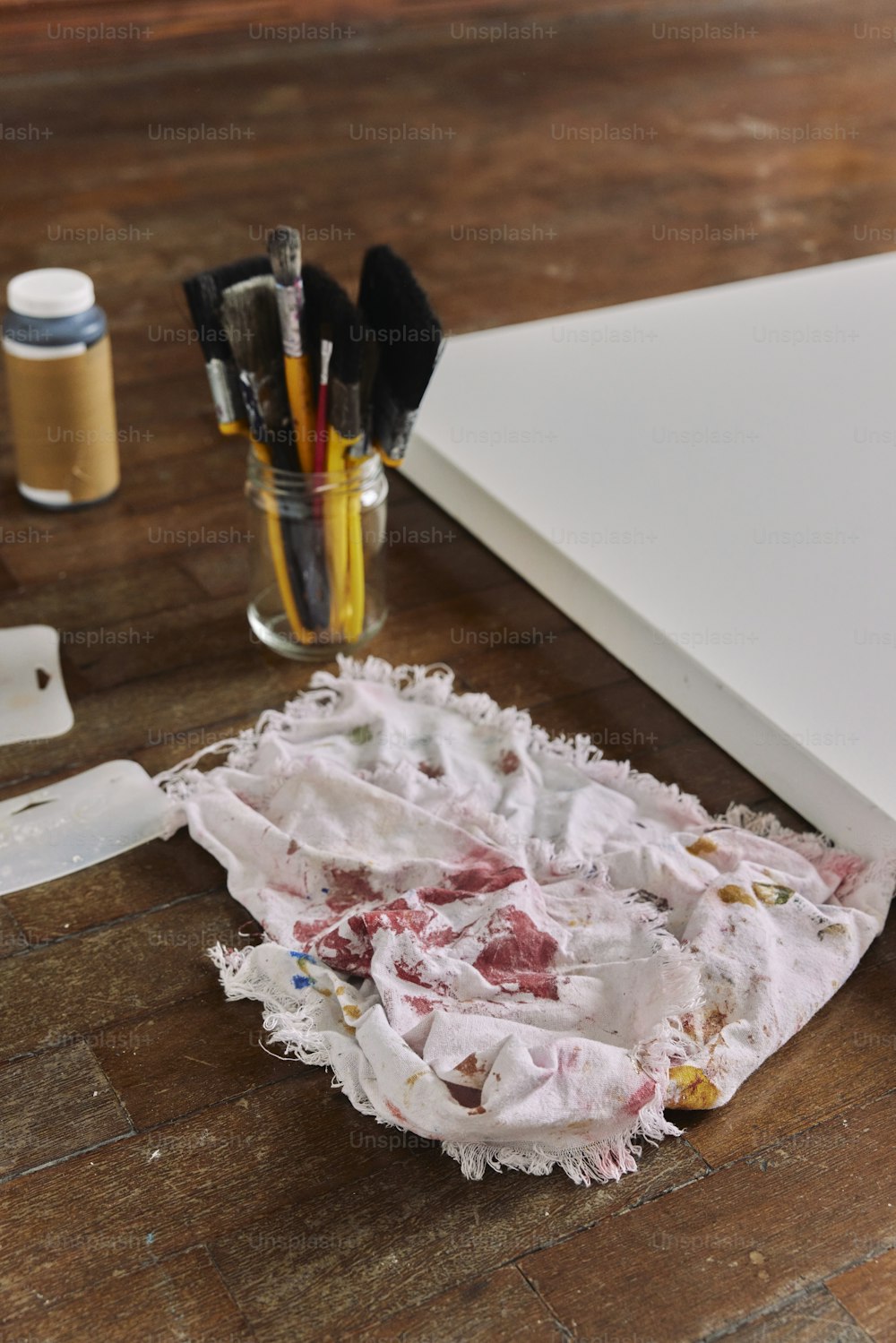 a piece of torn paper sitting on top of a wooden table