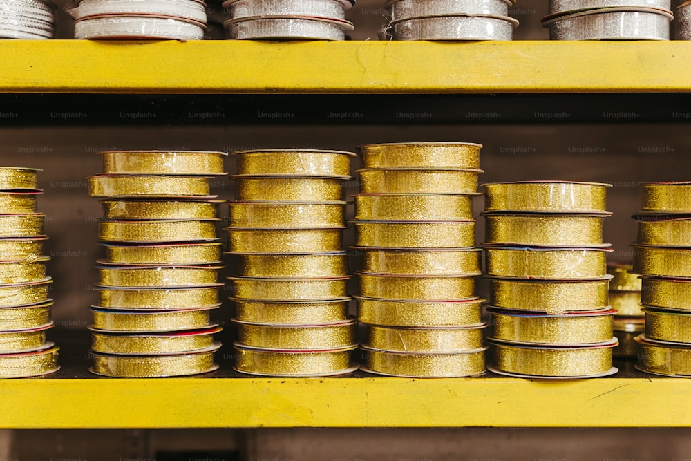a yellow shelf filled with lots of tin cans