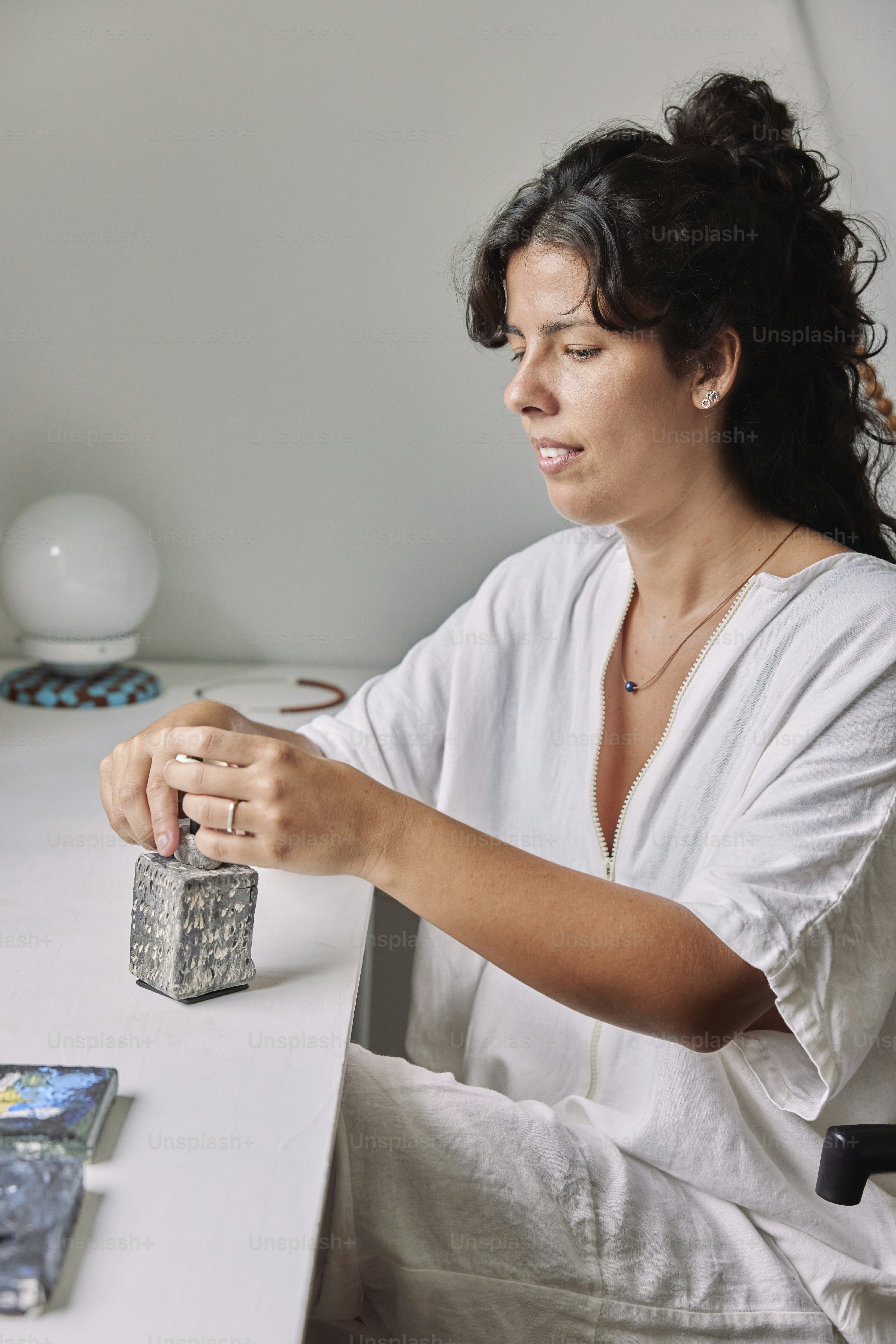a woman sitting at a table with a book