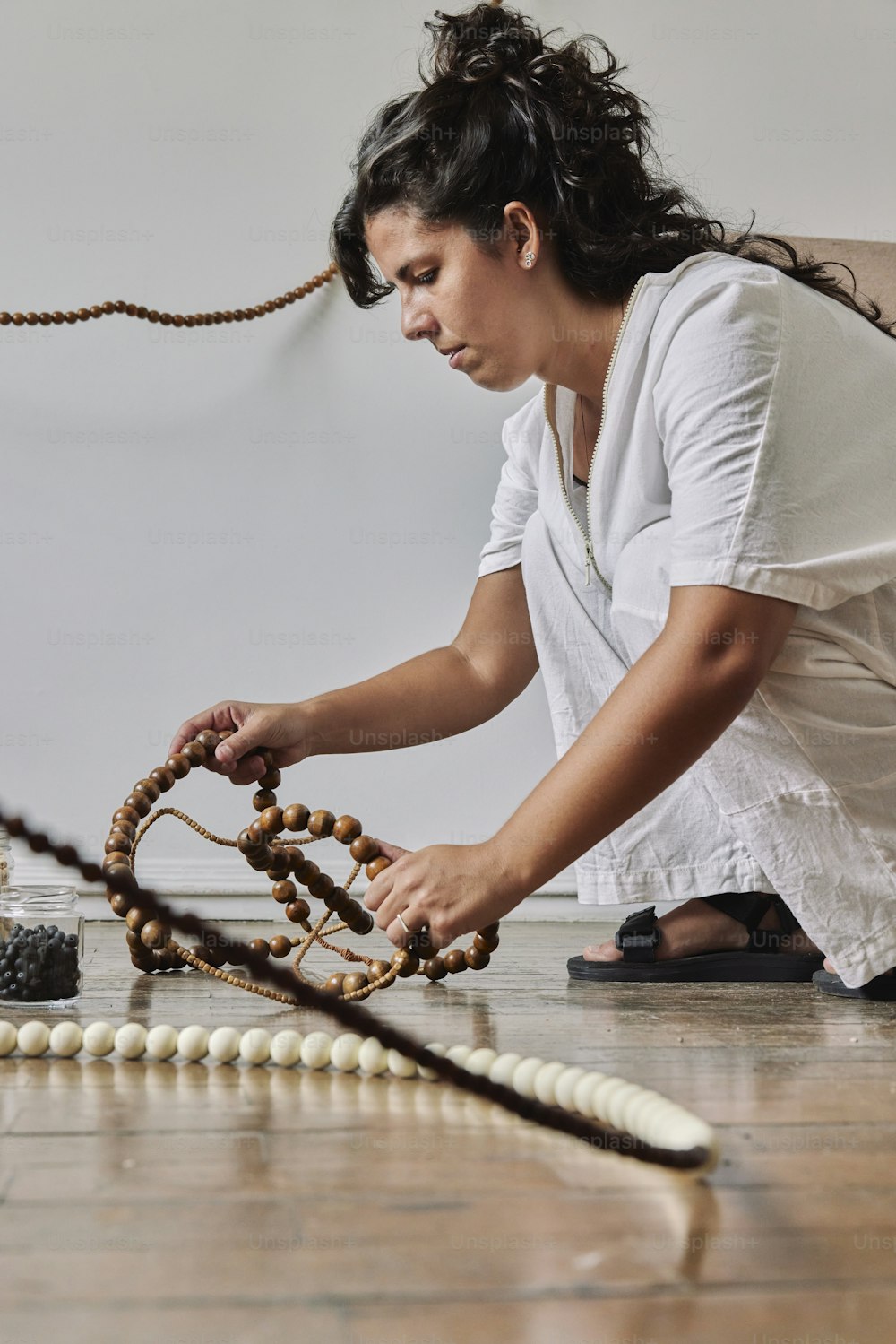 a woman in a white shirt and some beads